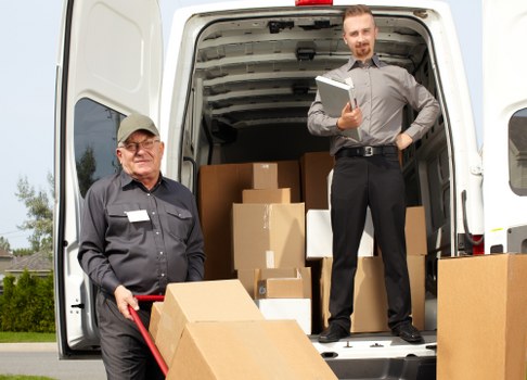Students moving boxes into secure storage in Hook