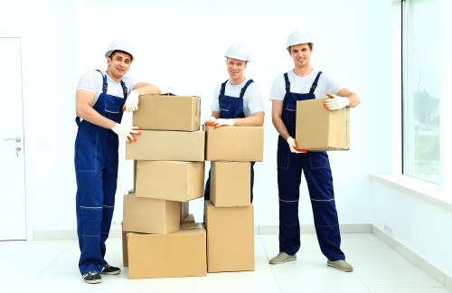 Team organizing household items with packing materials in Hook